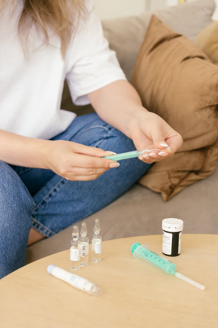 Close-up of a woman preparing a syringe with medication, highlighting healthcare and diabetes management.